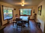 Dining room off the kitchen with large windows and deck access.
